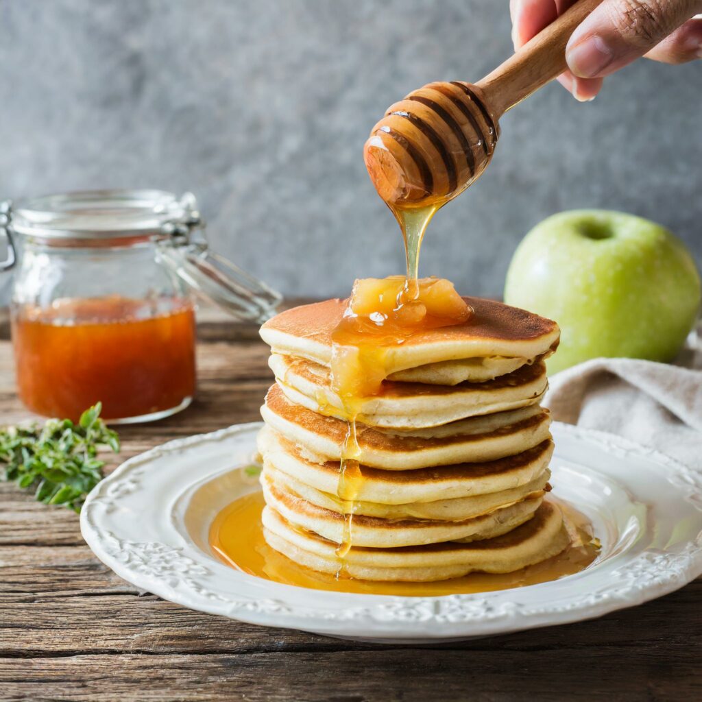 Stack of fluffy Gentle Oatmeal Pancakes for Gastritis, drizzled with golden honey, ready to be served as a gastritis-friendly treat.